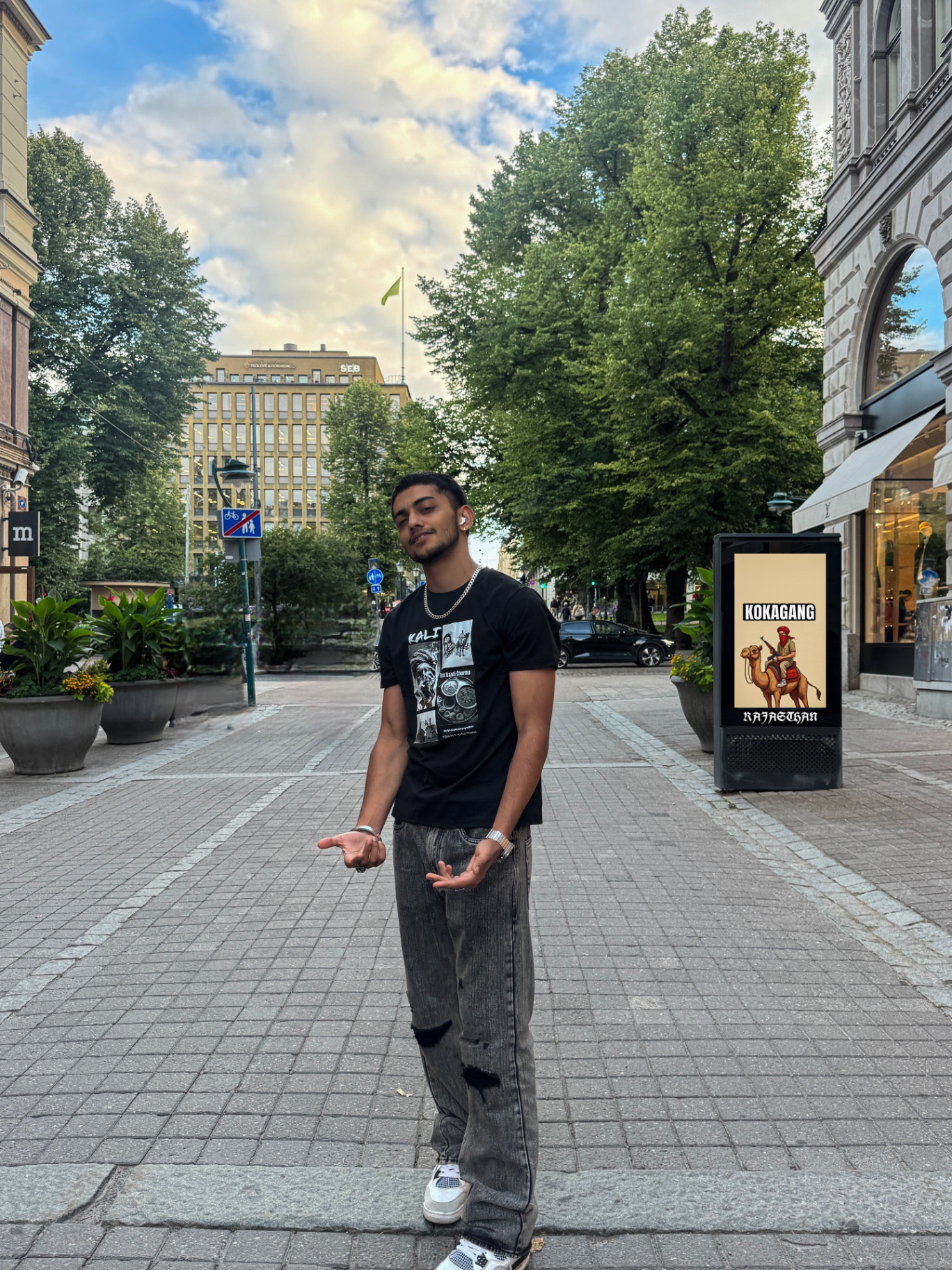 Person wearing the black Kali Rajasthani graphic tee on a city street in Helsinki